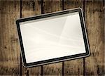 Digital tablet PC on a dark wood table - horizontal office mockup
