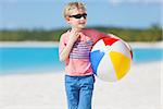 little boy with beach ball enjoying tropical vacation at bahamas