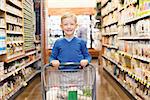 smiling little boy proud to do grocery shopping alone