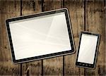 Smartphone and digital tablet PC on a dark wood table - horizontal office mockup