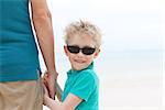 back view of young father and his smiling son at the beach vacation