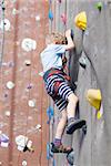 little boy rock climbing indoors, healthy lifestyle concept