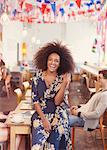 Portrait enthusiastic woman with afro in cafe