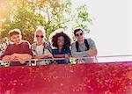 Portrait smiling friends riding double-decker bus