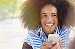 Enthusiastic woman listening to music with headphones and mp3 player