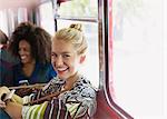 Portrait smiling blonde woman riding bus