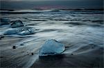 Ice on stormy cold ocean beach, Iceland