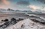 Snow covered mountain range over cold ocean, Budir, Snaefellsnes, Iceland