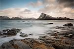 Scenic view mountains and cold craggy ocean, Vagje Lofoten Islands, Norway