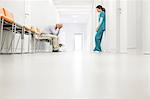 Stressed doctor and nurse in hospital corridor