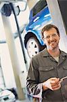 Portrait confident mechanic in auto repair shop