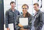 Portrait confident female mechanic with clipboard in auto repair shop