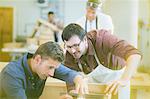 Carpenters working in workshop