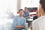 Professor and students talking in adult education classroom