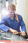 Mechanic working on engine in auto repair shop