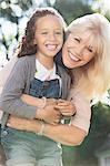 Portrait smiling grandmother and granddaughter hugging