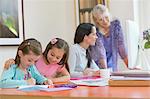 Multi-generation family doing homework and using computer