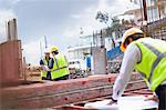 Engineer reviewing blueprints at construction site