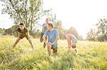 Group of friends exercising in field