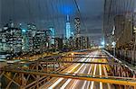 Elevated view of Brooklyn bridge and Manhattan financial district skyline at night, New York, USA