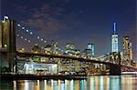 Night view of Manhattan financial district and Brooklyn bridge, New York, USA