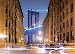 Manhattan Bridge and city apartments at night, New York, USA