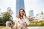 Businesswoman on smartphone, Warsaw, Poland