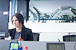 Businesswoman working on computer in office