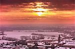 Sunset over snow covered rooftops, Cremona, Italy