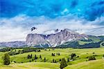 Fields and distant rock formation, Dolomites, Italy