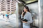 Businesswoman using smartphone on street