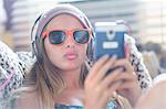 Teenager with sun glasses using smartphone on lazy chair