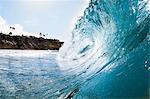 Surface level view of rolling ocean wave and coastline. Encinitas, California, USA