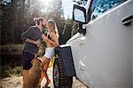 Romantic young couple kissing on riverside, Lake Tahoe, Nevada, USA