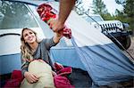 Young couple sharing snacks whilst camping, Lake Tahoe, Nevada, USA