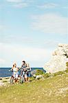 Family with bicycle at sea