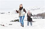 Woman walking with daughter at winter