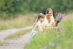 Mother with daughter picking wildflowers