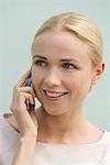 Woman talkiing on cell phone, smiling