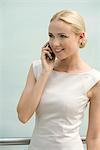 Young businesswoman talking on cell phone, smiling
