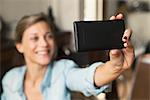 Woman taking selfie with smartphone
