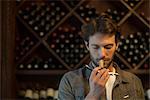 Sommelier sniffing wine cork