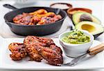 Grilled chicken legs and wings with guacamole, frish salad and spicies
