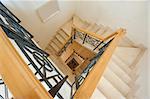 View down a spiral staircase inside a luxury villa residence