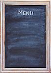 Old blackboard with white chalk and eraser for menu or price.