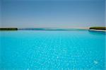 View from a luxury infinity swimming pool with tropical sea outlook