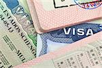 Chinese, USA and Shengen European visas in passports - adventure background