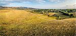 aerial panorama of foothills prairie along Front Range of Rocky Mountains near Fort Collins, Colorado, summer scenery lit by sunrise - - Cathy Fromme Prairie Natural Area with a bike trail