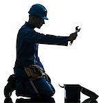 one  repairman worker despair praying silhouette in studio on white background