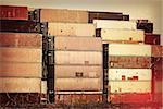 Nostalgia in the harbor - old container stacks in sepia and red colors with aging effects